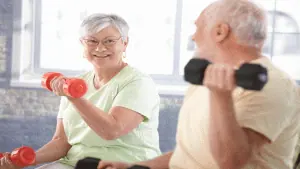casal de idosos praticando exercício de musculação