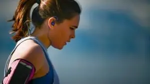 Mulher com fone de ouvido concentrada